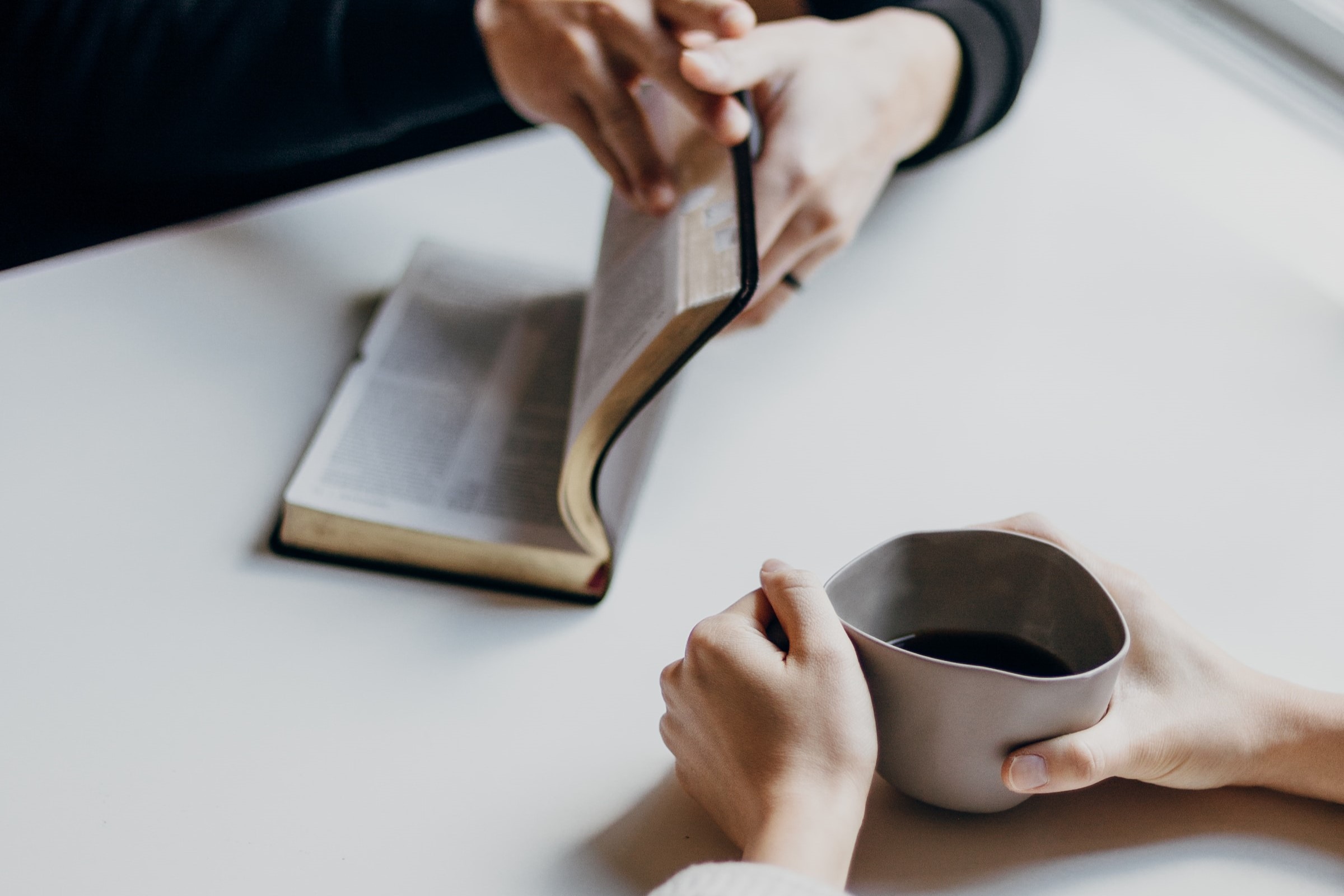 Praying bible study together with coffee